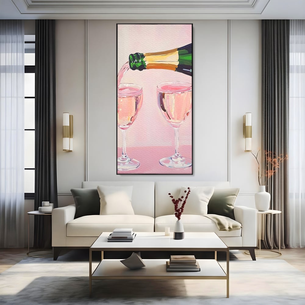 Tablou canvas cu pictura cu sticla si pahare de sampanie roz, in rama de aluminiu negru, pe perete intr-un living